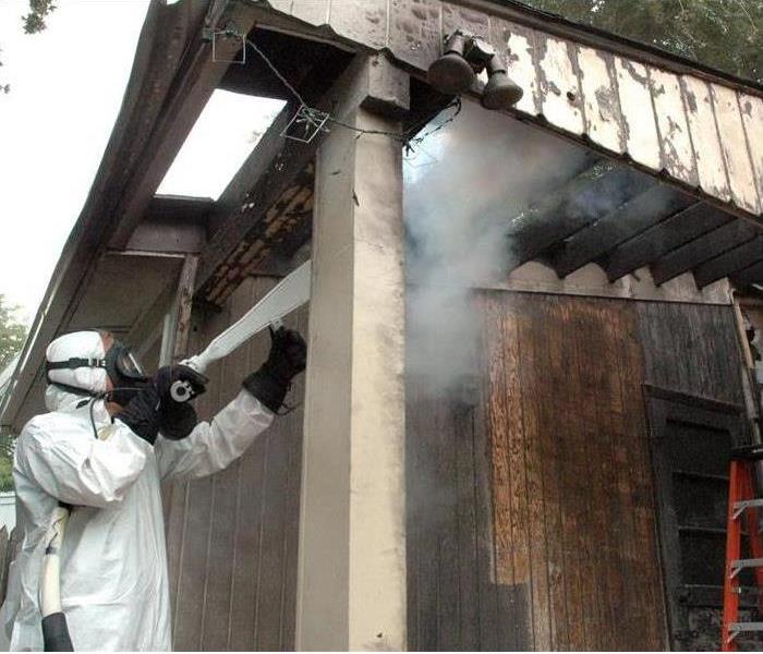 A specialist is cleaning a home after a fire damage
